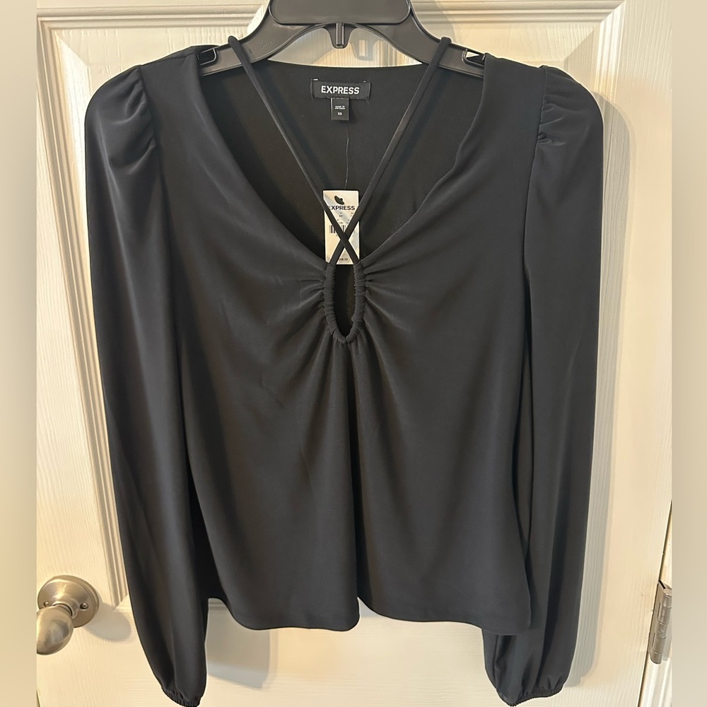 Express block long sleeve top with key hold detail. NWT. Size XS.